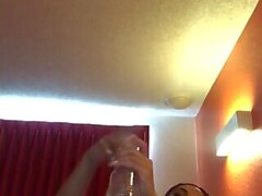 Using her sex toy in a hotel room and shooting a cumshot